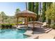 Luxury pool with a spa and thatched-roof cabana at 1975 Alcova Ridge Dr, Las Vegas, NV 89135