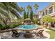 Inviting pool with fire pit and lounge chairs at 1975 Alcova Ridge Dr, Las Vegas, NV 89135