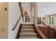 Elegant staircase with wood railing connecting the floors at 1975 Alcova Ridge Dr, Las Vegas, NV 89135