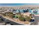 An aerial view of a residential neighborhood featuring a park, landscaping, and mountain views at 2905 Vigilante Ct, North Las Vegas, NV 89081