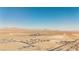 Sweeping aerial view showcasing desert community, distant mountain ranges, and expansive desert terrain at 2905 Vigilante Ct, North Las Vegas, NV 89081