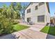 A backyard features a brick paved patio, artificial turf, a patio table set, and the home's exterior at 2905 Vigilante Ct, North Las Vegas, NV 89081