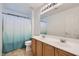 Bathroom with a double sink vanity, neutral wall paint and flooring, shower with curtain rod at 2905 Vigilante Ct, North Las Vegas, NV 89081