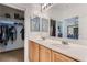 Bathroom showcasing a double sink vanity, storage, and a view into the main bedroom at 2905 Vigilante Ct, North Las Vegas, NV 89081