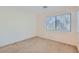 A bedroom features neutral carpet, a large window and ample natural light at 2905 Vigilante Ct, North Las Vegas, NV 89081