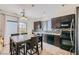 Eat in kitchen featuring dark cabinetry, stainless steel appliances, decorative tile backsplash, and a tile floor at 2905 Vigilante Ct, North Las Vegas, NV 89081