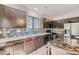 Modern kitchen boasts granite countertops, stainless steel appliances, mosaic backsplash, and ample cabinet space at 2905 Vigilante Ct, North Las Vegas, NV 89081