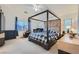 Spacious main bedroom suite with a canopy bed, ceiling fan, and ample natural light at 2905 Vigilante Ct, North Las Vegas, NV 89081