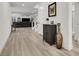 Bright foyer featuring wood-look tile flooring, modern decor, and an open view into the adjacent living room at 3197 Vittoria Ave, Henderson, NV 89044