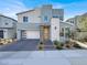 Modern two-story home featuring a brick driveway, a two-car garage, and professionally landscaped front yard at 3197 Vittoria Ave, Henderson, NV 89044
