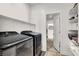 Functional laundry room with modern washer and dryer units and ample shelving at 3197 Vittoria Ave, Henderson, NV 89044
