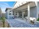 This covered patio features modern outdoor seating, a neutral color scheme and paved stone at 3197 Vittoria Ave, Henderson, NV 89044