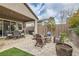Relaxing backyard patio with a fire pit, seating area, and a dining table at 3395 Sleeping Hills Ave, Henderson, NV 89044