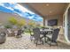 Spacious backyard patio with a dining set, fire pit, and ample seating at 3395 Sleeping Hills Ave, Henderson, NV 89044
