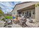 Artificial turf backyard with a firepit and patio seating at 3395 Sleeping Hills Ave, Henderson, NV 89044