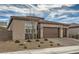 Tan three-car garage home with drought-tolerant landscaping at 3395 Sleeping Hills Ave, Henderson, NV 89044