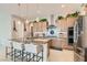 Modern kitchen with light-wood cabinets, granite countertops, and stainless steel appliances at 3395 Sleeping Hills Ave, Henderson, NV 89044