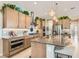 Modern kitchen with light wood cabinets, granite island, and stainless steel appliances at 3395 Sleeping Hills Ave, Henderson, NV 89044