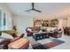 Living room with leather furniture, a ceiling fan, and open floor plan at 3395 Sleeping Hills Ave, Henderson, NV 89044