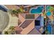 Bird's-eye view of the roof with solar panels and backyard oasis with a freeform pool and well-manicured landscaping at 395 Suzanne Peak Ct, Henderson, NV 89012