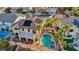 Aerial shot of a private backyard oasis featuring a freeform pool, jacuzzi, patio, and lush tropical landscaping at 395 Suzanne Peak Ct, Henderson, NV 89012