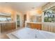 This bathroom features dual vanities, a large tub, and a bright window at 395 Suzanne Peak Ct, Henderson, NV 89012