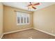 Bright bedroom features a ceiling fan and plantation shutters for natural light control at 395 Suzanne Peak Ct, Henderson, NV 89012