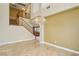Bright dining room with tiled floors, neutral walls, chandelier, and staircase with wood banister at 395 Suzanne Peak Ct, Henderson, NV 89012