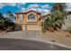 Charming two-story home with a terracotta tile roof, spacious garages, and desert landscaping at 395 Suzanne Peak Ct, Henderson, NV 89012