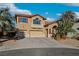 Charming two-story home with a terracotta tile roof, spacious garages, and desert landscaping at 395 Suzanne Peak Ct, Henderson, NV 89012