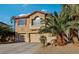 Inviting two-story home featuring a terracotta tile roof, spacious garages, and desert landscaping at 395 Suzanne Peak Ct, Henderson, NV 89012
