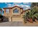 Inviting two-story home featuring a terracotta tile roof, spacious garages, and desert landscaping at 395 Suzanne Peak Ct, Henderson, NV 89012