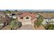 Well-maintained home with a three car garage and red window shutters and tile roof at 395 Suzanne Peak Ct, Henderson, NV 89012