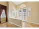 Bright foyer featuring high ceilings, tile flooring, and decorative glass double doors at 395 Suzanne Peak Ct, Henderson, NV 89012