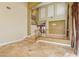 Foyer features high ceilings, tile floors, staircase with wood railing, and neutral wall color at 395 Suzanne Peak Ct, Henderson, NV 89012