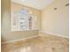 Light-filled foyer with tile flooring and tall ceilings with a decorative transom window above the front doors at 395 Suzanne Peak Ct, Henderson, NV 89012