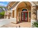 Inviting front entrance featuring a double door, arched entryway and desert landscaping at 395 Suzanne Peak Ct, Henderson, NV 89012