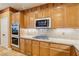 Modern kitchen with granite counters, stainless steel appliances, and gas cooktop at 395 Suzanne Peak Ct, Henderson, NV 89012
