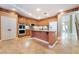 Spacious kitchen with granite counters, stainless appliances, and tiled floors offers style and function at 395 Suzanne Peak Ct, Henderson, NV 89012