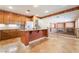 Bright eat-in kitchen features granite countertops, travertine floors, wood cabinets, and a large center island at 395 Suzanne Peak Ct, Henderson, NV 89012