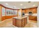 Spacious kitchen with granite countertops, wooden cabinetry, and large center island at 395 Suzanne Peak Ct, Henderson, NV 89012