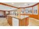 Spacious kitchen features a center island, tile flooring, and bright natural light at 395 Suzanne Peak Ct, Henderson, NV 89012