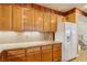 Kitchen area features light countertops, wood cabinets, and stainless refrigerator appliance at 395 Suzanne Peak Ct, Henderson, NV 89012