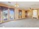 Spacious living room with carpet floors, access to a balcony, and good natural lighting at 395 Suzanne Peak Ct, Henderson, NV 89012