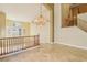 Bright living room with tiled floors, staircase with wood banister, and tall ceilings at 395 Suzanne Peak Ct, Henderson, NV 89012