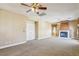 Spacious living room featuring carpet floors, a fireplace, and neutral colored walls at 395 Suzanne Peak Ct, Henderson, NV 89012