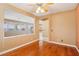 Cozy living room featuring hardwood floors, natural light, and a ceiling fan at 395 Suzanne Peak Ct, Henderson, NV 89012