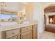 Well-lit main bathroom features tiled floors, spacious vanity, and relaxing views out the picture window at 395 Suzanne Peak Ct, Henderson, NV 89012