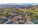 Sprawling neighborhood featuring varied home styles, mature trees, and a green golf course set against a stunning mountain vista at 395 Suzanne Peak Ct, Henderson, NV 89012