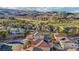 Upscale community with well-kept homes, lush landscaping, a golf course, and scenic mountain views in the background at 395 Suzanne Peak Ct, Henderson, NV 89012